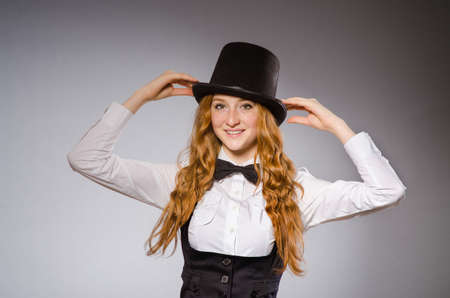 Red hair girl in classic style against gray
