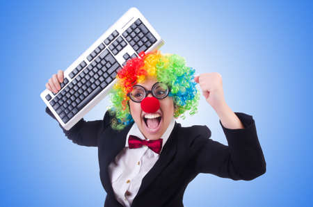 Funny clown with keyboard on whiteの写真素材