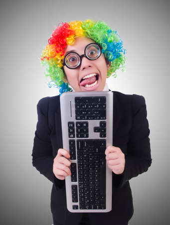 Funny clown with keyboard on whiteの写真素材