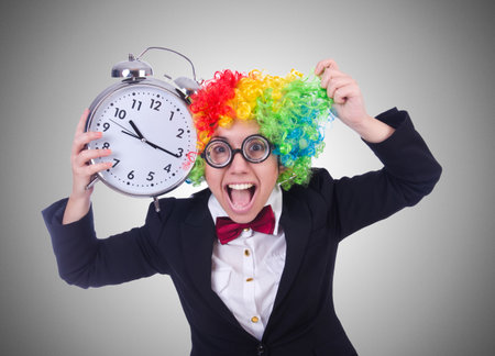 Funny clown with clock on whiteの写真素材