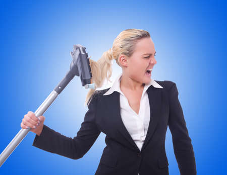Businesswoman with vacuum cleaner on whiteの写真素材