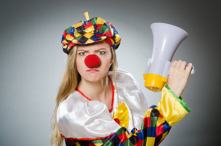 Clown with loudspeaker isolated on whiteの写真素材