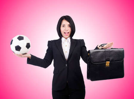 Businesswoman with ball on whiteの写真素材