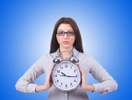 Woman with clock isolated on whiteの写真素材