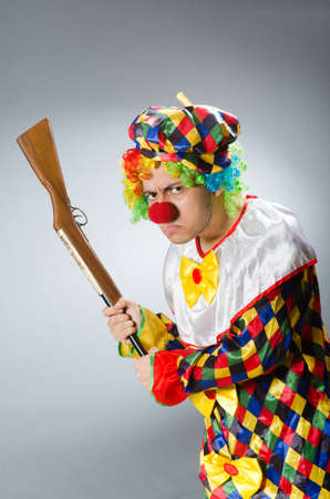 Clown with rifle isolated on whiteの写真素材