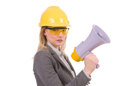 Female engineer in helmet with loudspeaker isolated on whiteの写真素材