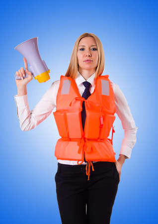 Young woman with vest and loudspeaker on whiteの写真素材