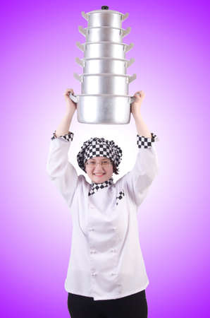 Cook with stack of pots on whiteの写真素材