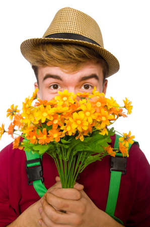 Young gardener with flower isolated on whiteの写真素材
