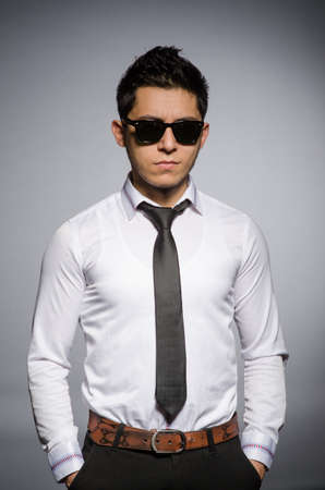 Young caucasian man against grayの写真素材