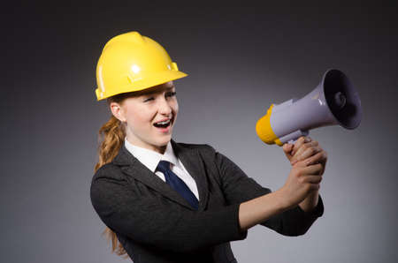 Construction worker in helmet against grayの写真素材