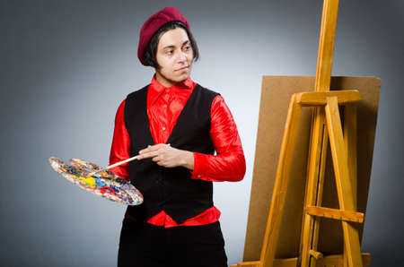 Funny artist in dark studio