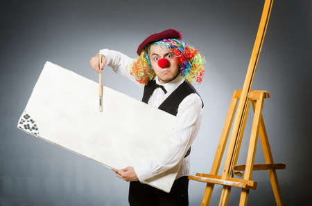 Funny artist in dark studio