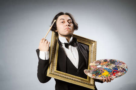 Funny artist in dark studioの写真素材