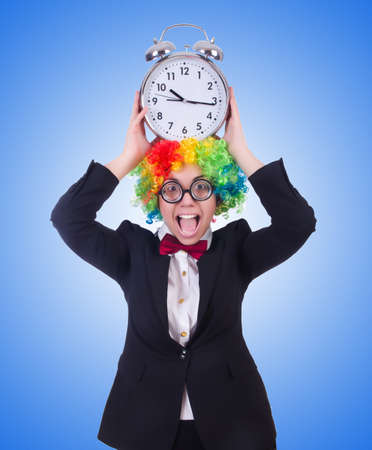 Funny clown with clock on whiteの写真素材