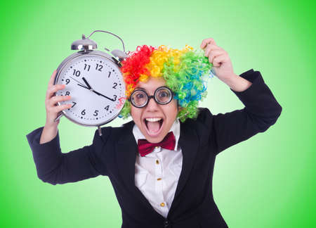 Funny clown with clock on whiteの写真素材