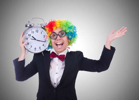 Funny clown with clock on whiteの写真素材