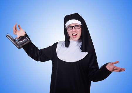 Nun with handgun isolated on whiteの写真素材