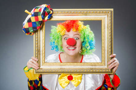 Clown with picture frame in funny conceptの写真素材