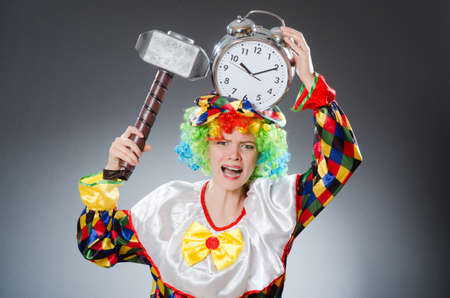 Clown with hammer and clockの写真素材