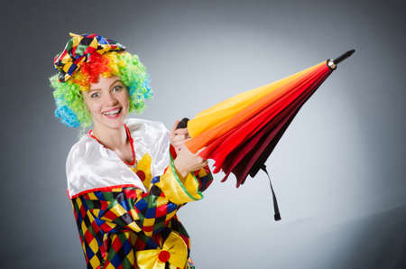 Clown with umbrella in funny conceptの写真素材
