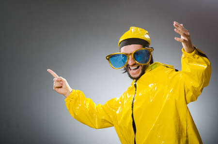 Man wearing yellow suit in funny conceptの写真素材