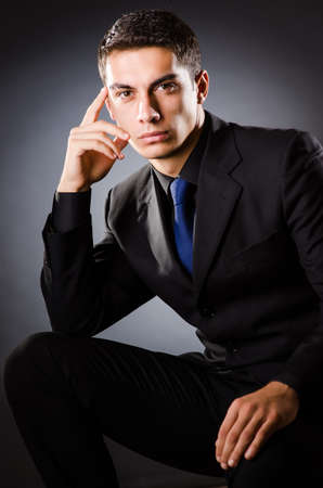 Young elegant man against grayの写真素材