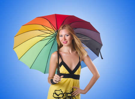 Young woman with colourful umbrellaの写真素材