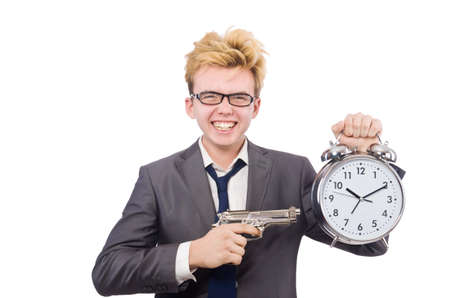 Young businessman holidng gun and alarm clock isolated on whiteの写真素材