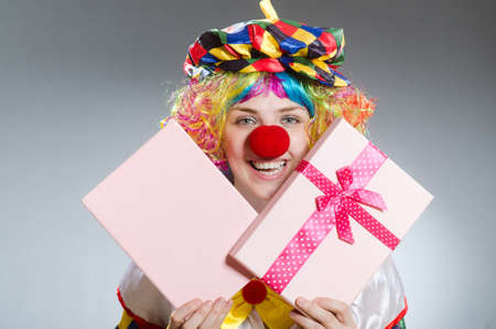 Clown with giftbox in funny conceptの写真素材