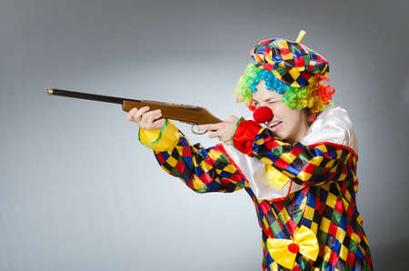 Clown with rifle isolated on whiteの写真素材