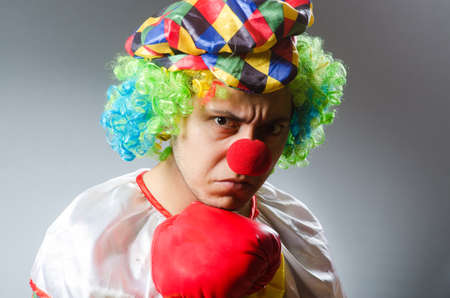 Clown with boxing gloves isolated on white