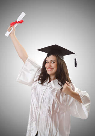 Graduate with diploma on whiteの写真素材