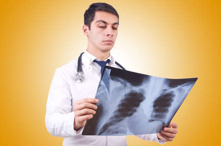 Young doctor with x-ray image on white