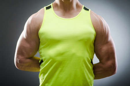 Muscular man posing in dark studioの写真素材