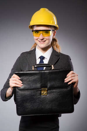 Construction worker in helmet against grayの写真素材