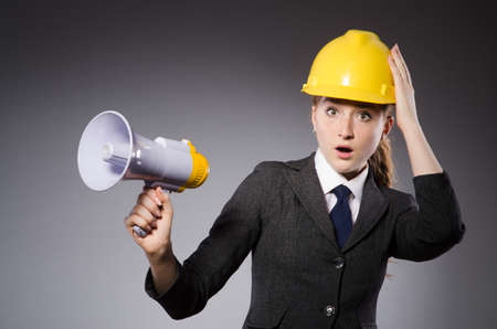 Construction worker in helmet against grayの写真素材
