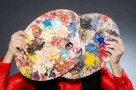 Funny artist in dark studioの写真素材