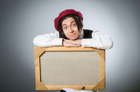 Funny artist in dark studioの写真素材