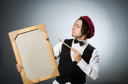 Funny artist in dark studioの写真素材