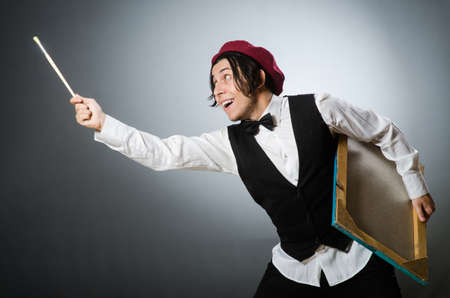 Funny artist in dark studioの写真素材