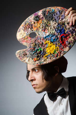 Funny artist in dark studioの写真素材