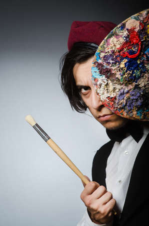 Funny artist in dark studioの写真素材