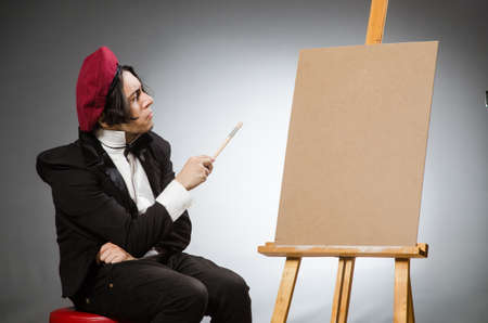 Funny artist in dark studioの写真素材