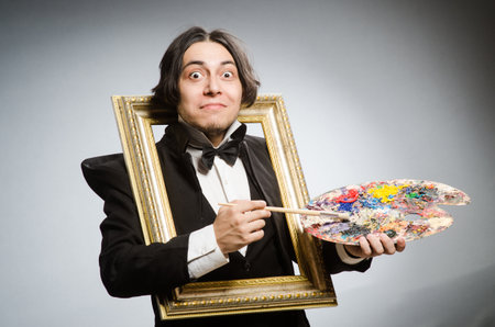 Funny artist in dark studioの写真素材