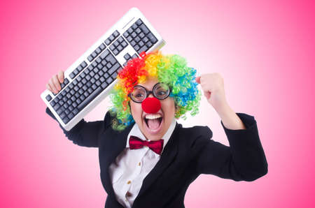 Funny clown with keyboard on whiteの写真素材