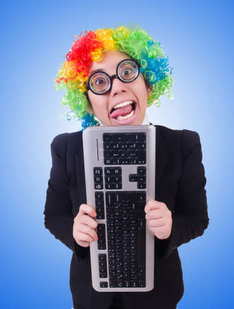 Funny clown with keyboard on whiteの写真素材