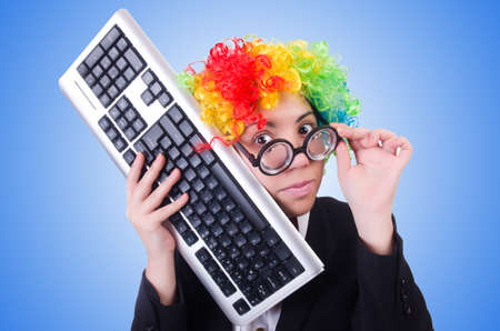 Funny clown with keyboard on whiteの写真素材