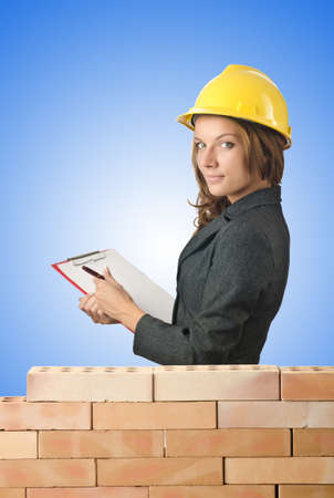 Woman architect near brick wallの写真素材