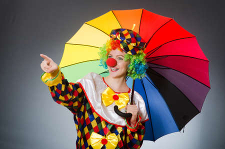 Clown with umbrella in funny conceptの写真素材
